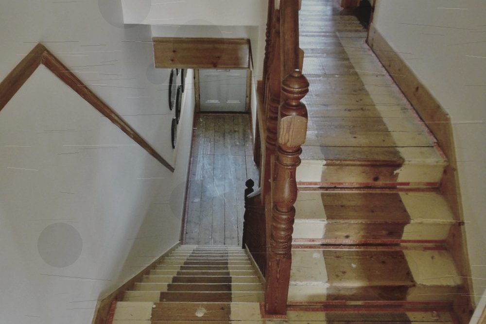 Worn wooden staircase before refinishing