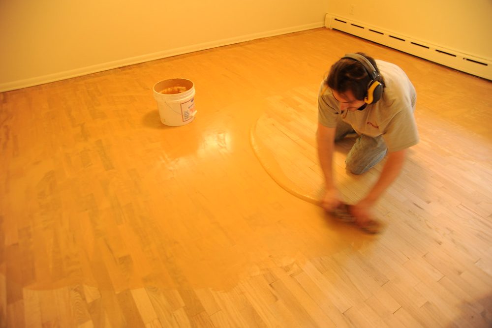 Dustless floor sander refinishing a hardwood floor